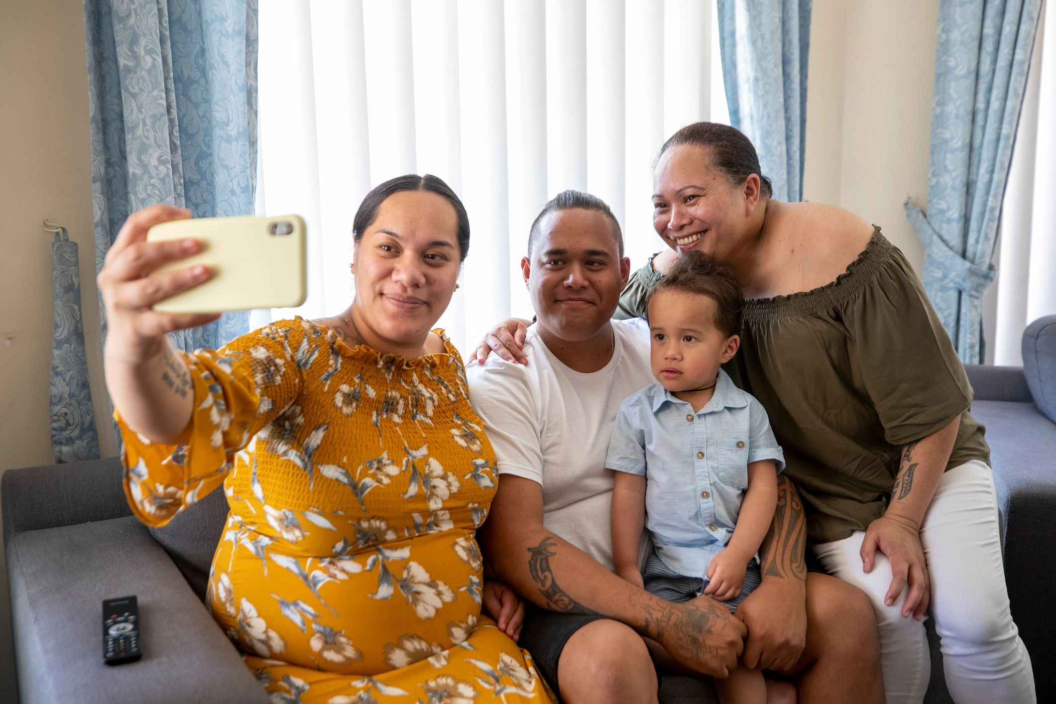 Marshallese family together at home smiling for a photo