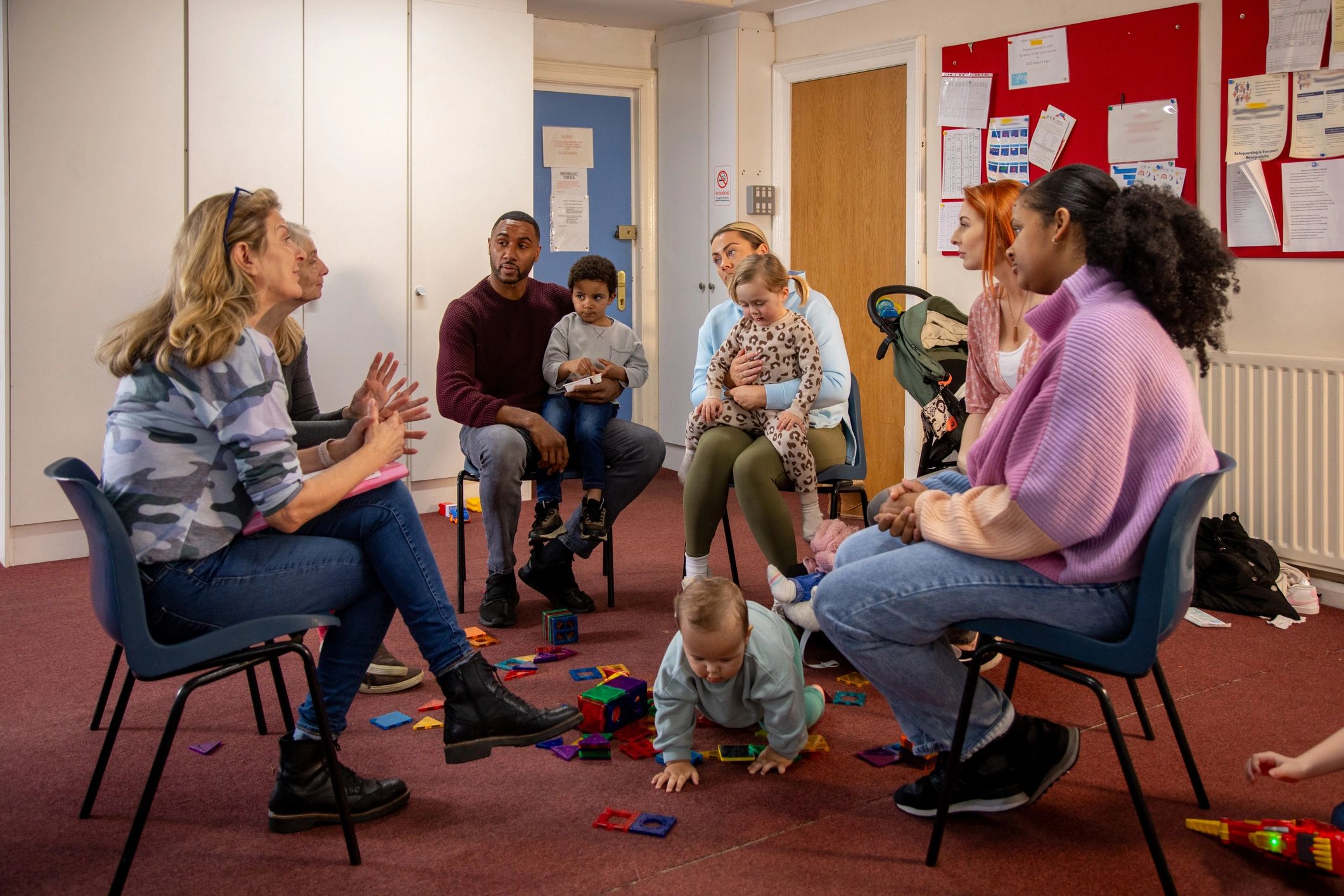 Caregivers and children connecting in a community support setting
