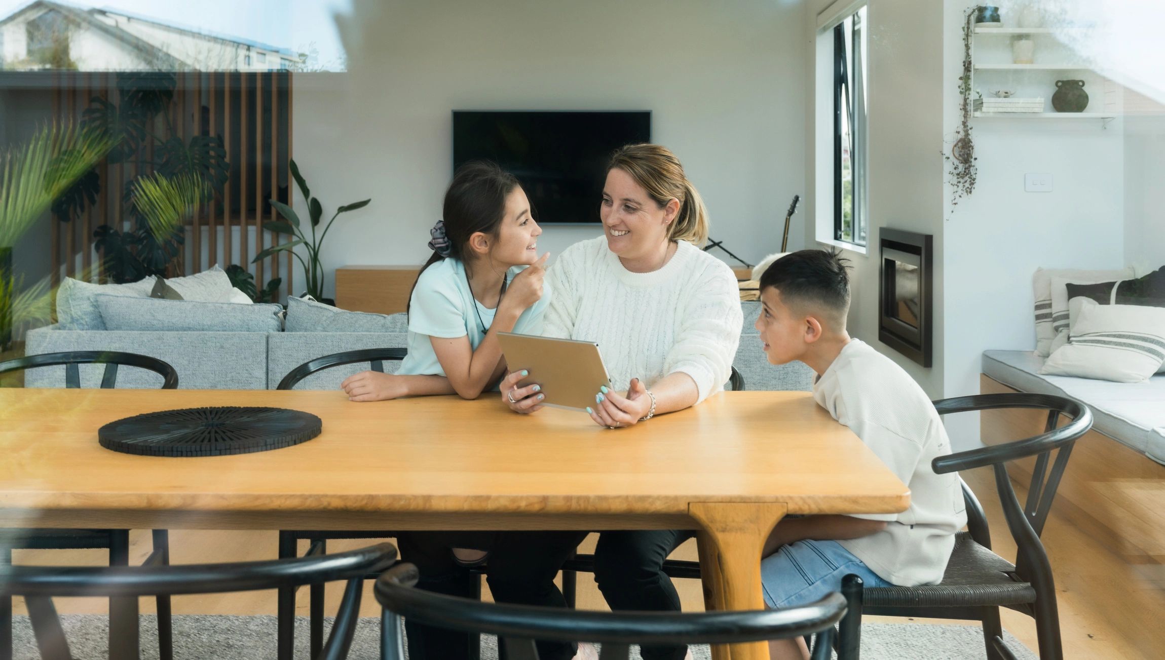 Caregivers and children spending time together using a tablet
